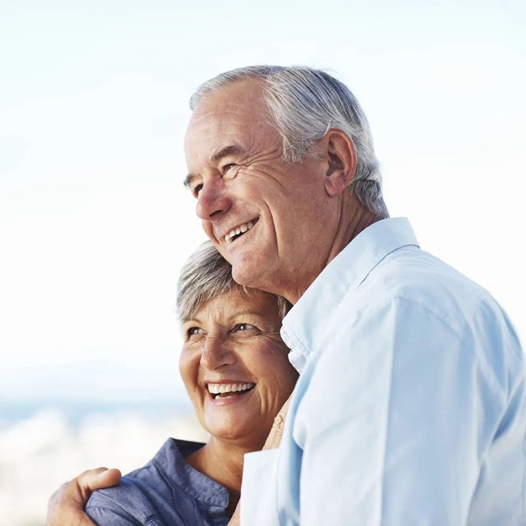 Elderly Couple in front of beach